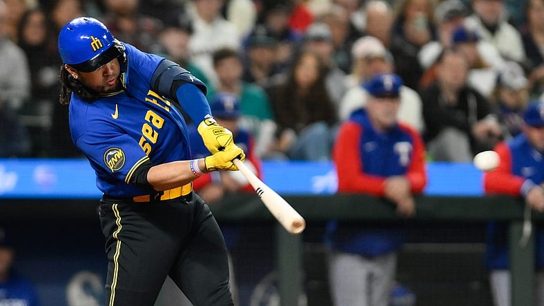 Sep 29, 2023; Seattle, Washington, USA; Seattle Mariners third baseman Eugenio Suarez (28) hits an RBI double against the Texas Rangers during the third inning at T-Mobile Park. Mandatory Credit: Steven Bisig-USA TODAY Sports