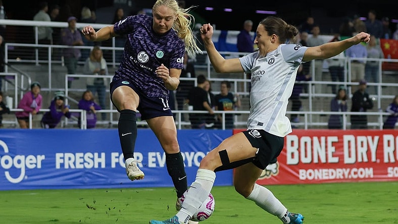 Oct 6, 2023; Louisville, Kentucky, USA; Racing Louisville FC midfielder Maddie Pokorny (17) and Orlando Pride forward Messiah Bright (23) battle for the ball in the second half at Lynn Family Stadium. Mandatory Credit: EM Dash-USA TODAY Sports