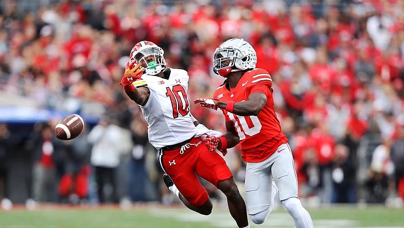 Oct 7, 2023; Columbus, Ohio, USA;  Maryland Terrapins wide receiver Tai Felton (10) attempts to one hand catch the football as Ohio State Buckeyes cornerback Denzel Burke (10) defends during the first quarter at Ohio Stadium. Mandatory Credit: Joseph Maiorana-USA TODAY Sports
