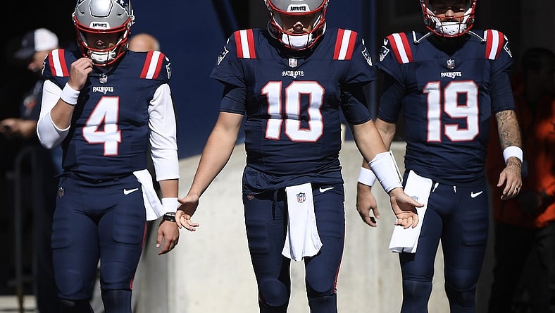 Oct 8, 2023; Foxborough, Massachusetts, USA; New England Patriots quarterback Bailey Zappe (4) quarterback Mac Jones (10) and quarterback Will Grier (19) walk out of the tunnel prior to a game against the New Orleans Saints at Gillette Stadium. Mandatory Credit: Bob DeChiara-USA TODAY Sports