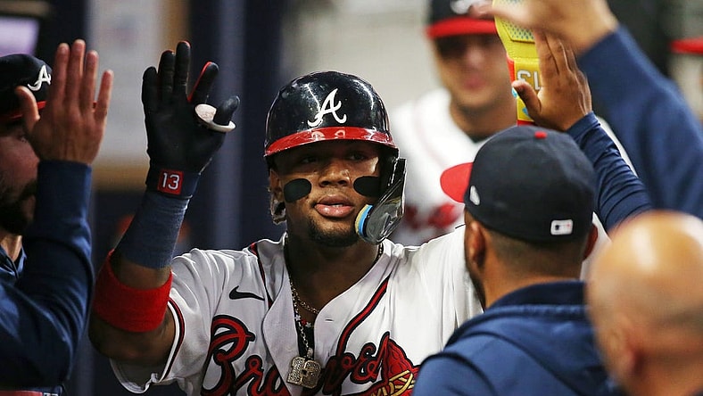 Oct 9, 2023; Cumberland, Georgia, USA; Atlanta Braves right fielder Ronald Acuna Jr. (13) celebrates in the dugout after scoring a run during the sixth inning against the Philadelphia Phillies in game two of the NLDS for the 2023 MLB playoffs at Truist Park. Mandatory Credit: Brett Davis-USA TODAY Sports