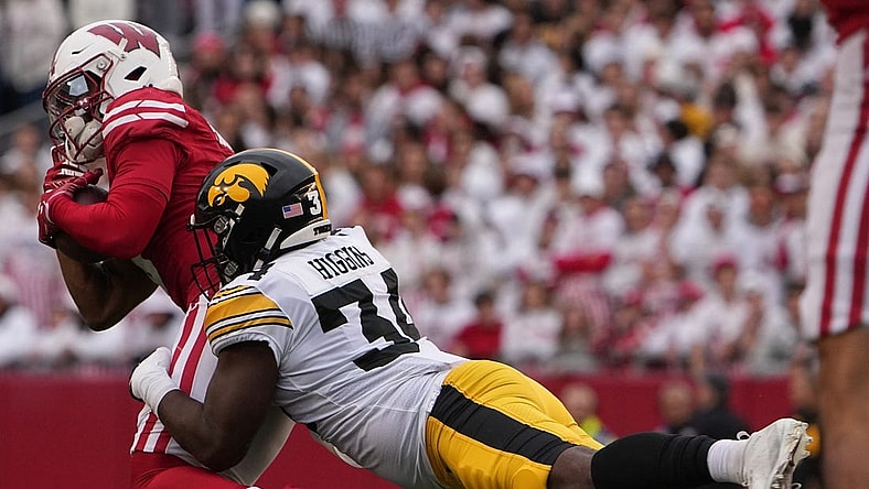 Oct 14, 2023; Madison, Wisconsin, USA; Wisconsin Badgers wide receiver Will Pauling (6) is tackled short of a first down by Iowa Hawkeyes linebacker Jay Higgins (34) during the second quarter at Camp Randall Stadium. Mandatory Credit: Mark Hoffman-USA TODAY Sports