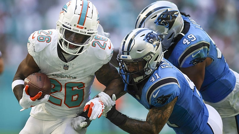 Oct 15, 2023; Miami Gardens, Florida, USA; Miami Dolphins running back De'Von Achane (28) runs with the football against Carolina Panthers safety Matthias Farley (41) during the fourth quarter at Hard Rock Stadium. Mandatory Credit: Sam Navarro-USA TODAY Sports