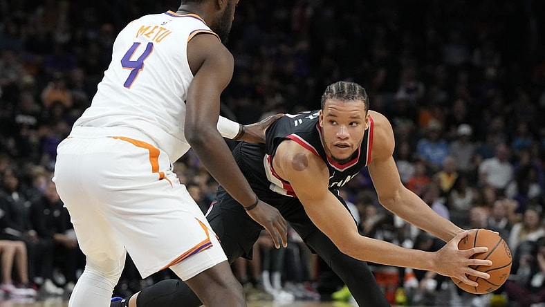 Oct 16, 2023; Phoenix, Arizona, USA; Portland Trail Blazers forward Kevin Knox II (11) looks to drive on Phoenix Suns forward Chimezie Metu (4) in the second half at Footprint Center. Mandatory Credit: Rick Scuteri-USA TODAY Sports