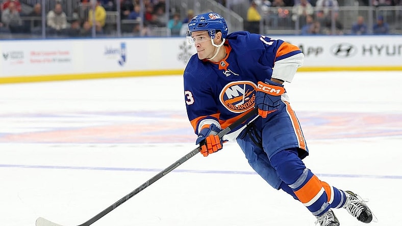 Oct 20, 2023; Elmont, New York, USA; New York Islanders center Mathew Barzal (13) skates with the puck against the New Jersey Devils during overtime at UBS Arena. Mandatory Credit: Brad Penner-USA TODAY Sports