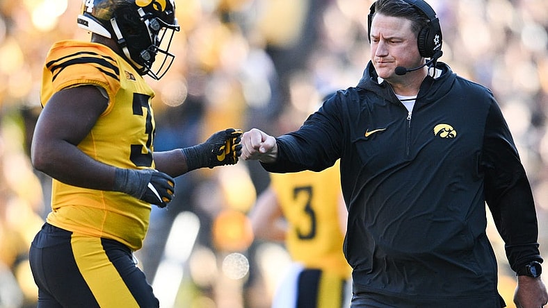 Iowa Hawkeyes assistant coach Brian Ferentz greets Big Ten leading tackler Jay Higgins (34) as he returns to the sideline during the second quarter against the Minnesota Golden Gophers at Kinnick Stadium. Mandatory Credit: Jeffrey Becker-USA TODAY Sports