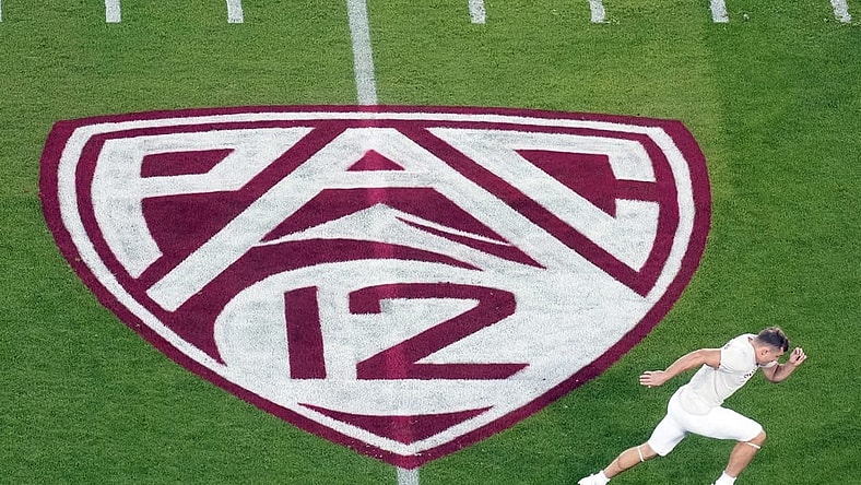 Oct 21, 2023; Stanford, California, USA; A view of the Pac-12 logo on the field as Stanford Cardinal wide receiver David Kasemervisz (80) warms up before the game against the UCLA Bruins at Stanford Stadium. Mandatory Credit: Darren Yamashita-USA TODAY Sports