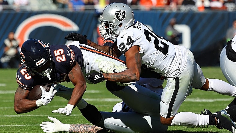 Oct 22, 2023; Chicago, Illinois, USA; Chicago Bears running back Darrynton Evans (25) rushes the ball against Las Vegas Raiders cornerback Marcus Peters (24) in the second half at Soldier Field. Mandatory Credit: Mike Dinovo-USA TODAY Sports