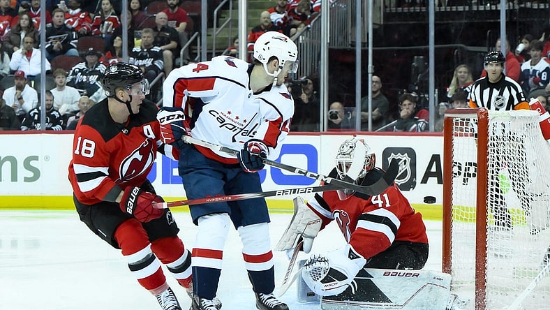 Oct 25, 2023; Newark, New Jersey, USA; Washington Capitals center Connor McMichael (24) scores a goal against New Jersey Devils goaltender Vitek Vanecek (41) during the third period at Prudential Center. Mandatory Credit: John Jones-USA TODAY Sports