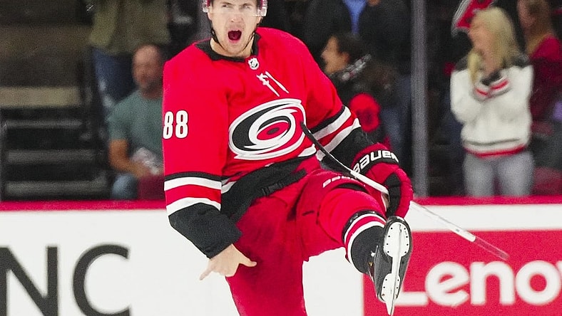 Oct 26, 2023; Raleigh, North Carolina, USA; Carolina Hurricanes center Martin Necas (88) celebrates his game winning goal in the overtime against the Seattle Kraken at PNC Arena. Mandatory Credit: James Guillory-USA TODAY Sports