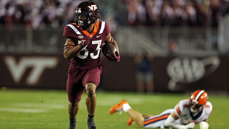 Oct 26, 2023; Blacksburg, Virginia, USA; Virginia Tech Hokies running back Bhayshul Tuten (33) runs the ball against Syracuse Orange defensive back Justin Barron (8) during the fourth quarter at Lane Stadium. Mandatory Credit: Peter Casey-USA TODAY Sports