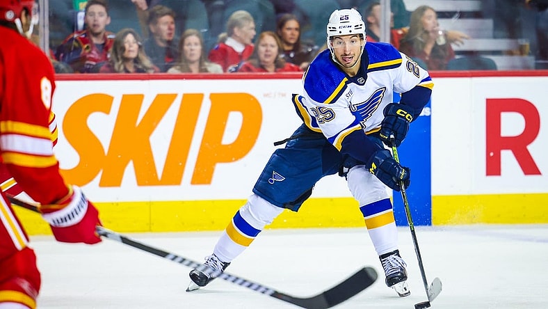 Oct 26, 2023; Calgary, Alberta, CAN; St. Louis Blues center Jordan Kyrou (25) controls the puck against the Calgary Flames during the third period at Scotiabank Saddledome. Mandatory Credit: Sergei Belski-USA TODAY Sports