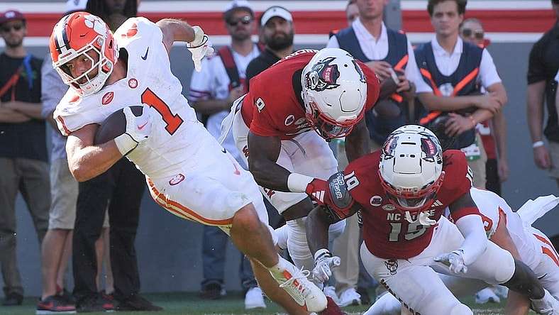 Oct 28, 2023; Raleigh, North Carolina, USA; Clemson Tigers running back Will Shipley (1) twists on a run before he is hit by North Carolina State Wolfpack cornerback Shyheim Battle (7) near the goal line during the second quarter at Carter-Finley Stadium. Mandatory Credit: Ken Ruinard-USA TODAY Sports