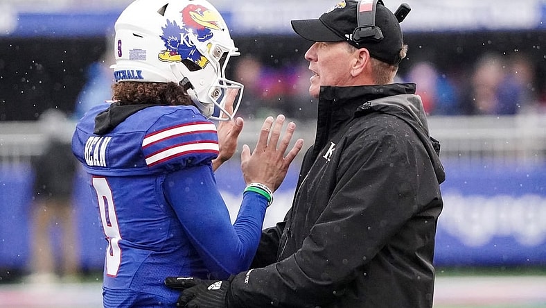 Oct 28, 2023; Lawrence, Kansas, USA; Kansas Jayhawks quarterback Jason Bean (9) talks with Kansas Jayhawks Kansas Jayhawks on field against the Oklahoma Sooners during the second half at David Booth Kansas Memorial Stadium. Mandatory Credit: Denny Medley-USA TODAY Sports