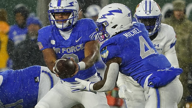 Oct 28, 2023; Fort Collins, Colorado, USA;  Air Force Falcons quarterback Zac Larrier (9) hands off to Air Force Falcons fullback Emmanuel Michel (4) at Sonny Lubick Field at Canvas Stadium. Mandatory Credit: Michael Madrid-USA TODAY Sports