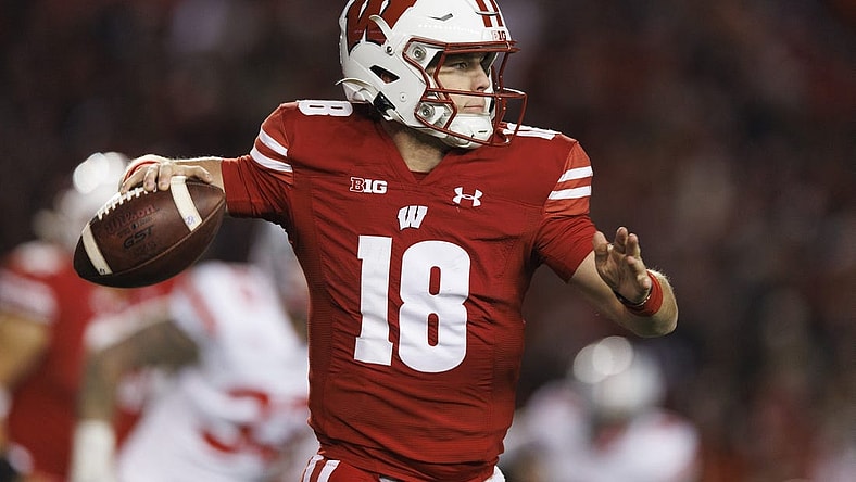 Oct 28, 2023; Madison, Wisconsin, USA;  Wisconsin Badgers quarterback Braedyn Locke (18) throws a pass during the fourth quarter against the Ohio State Buckeyes at Camp Randall Stadium. Mandatory Credit: Jeff Hanisch-USA TODAY Sports