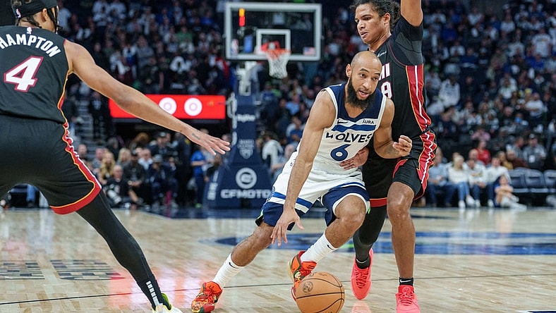 Oct 28, 2023; Minneapolis, Minnesota, USA; Minnesota Timberwolves guard Jordan McLaughlin (6) dribbles by Miami Heat guard Dru Smith (9) in the fourth quarter at Target Center. Mandatory Credit: Matt Blewett-USA TODAY Sports