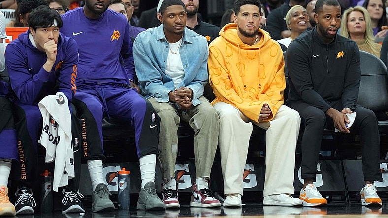 Oct 28, 2023; Phoenix, Arizona, USA; Bradley Beal (blue shirt) and Devin Booker (orange shirt) look on against the Utah Jazz during the first half at Footprint Center. Mandatory Credit: Joe Camporeale-USA TODAY Sports