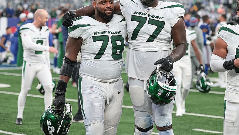 Oct 29, 2023; East Rutherford, New Jersey, USA; New York Jets guard Laken Tomlinson (78) and offensive tackle Mekhi Becton (77) walk off the field after defeating the New York Giants in overtime at MetLife Stadium. Mandatory Credit: Vincent Carchietta-USA TODAY Sports