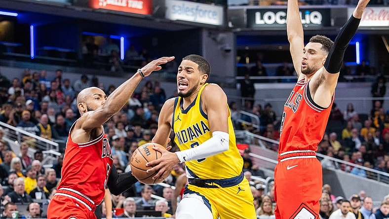 Oct 30, 2023; Indianapolis, Indiana, USA; Indiana Pacers guard Tyrese Haliburton (0) dribbles the ball while Chicago Bulls guard Jevon Carter (5) and guard Zach LaVine (8) defend in the second half at Gainbridge Fieldhouse. Mandatory Credit: Trevor Ruszkowski-USA TODAY Sports