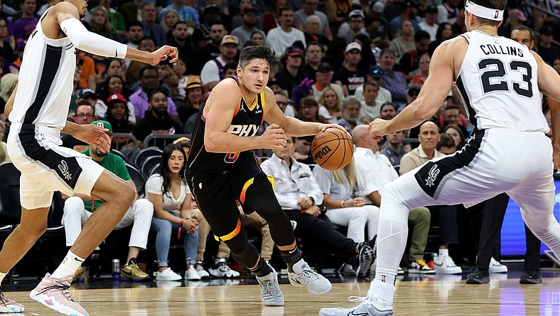 Oct 31, 2023; Phoenix, Arizona, USA; Phoenix Suns guard Grayson Allen #8 drives to the net agaisnt San Antonio Spurs center Victor Wembanyama #1 and forward Jeremy Sochan #10 during the second quarter at Footprint Center. Mandatory Credit: Zachary BonDurant-USA TODAY Sports