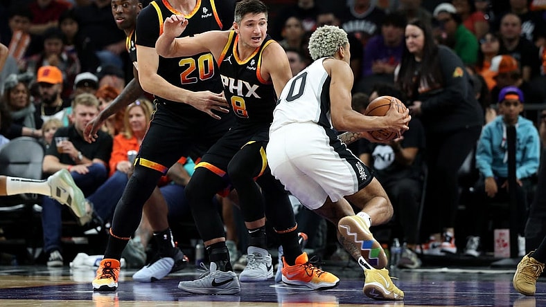 Oct 31, 2023; Phoenix, Arizona, USA; San Antonio Spurs forward Jeremy Sochan #10 drives to the net agaisnt Phoenix Suns guard Grayson Allen #8 and center Jusuf Nurkic #20 during the second half at Footprint Center. Mandatory Credit: Zachary BonDurant-USA TODAY Sports