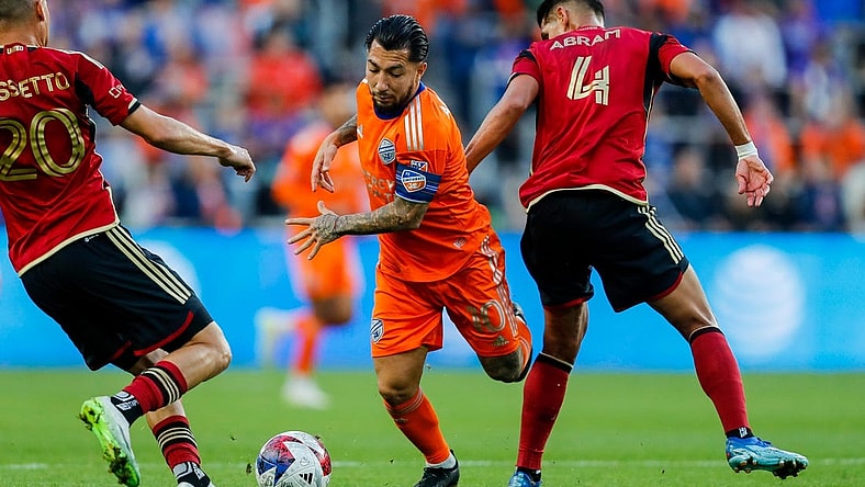 Oct 21, 2023; Cincinnati, Ohio, USA; FC Cincinnati midfielder Luciano Acosta (10) battles for the ball against Atlanta United FC midfielder Matheus Rossetto (20) and defender Luis Abram (4) in the first half at TQL Stadium. Mandatory Credit: Katie Stratman-USA TODAY Sports