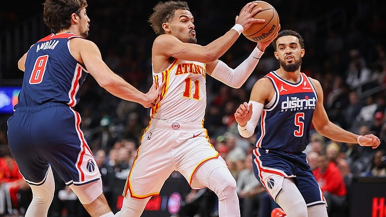 Nov 1, 2023; Atlanta, Georgia, USA; Atlanta Hawks guard Trae Young (11) drives past Washington Wizards forward Deni Avdija (8) and guard Tyus Jones (5) in the first quarter at State Farm Arena. Mandatory Credit: Brett Davis-USA TODAY Sports