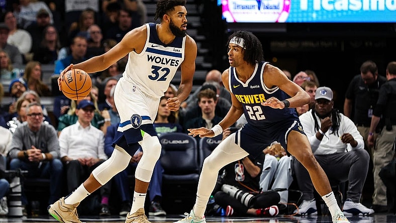 Nov 1, 2023; Minneapolis, Minnesota, USA; Minnesota Timberwolves center Karl-Anthony Towns (32) dribbles while Denver Nuggets forward Zeke Nnaji (22) defends during the first half at Target Center. Mandatory Credit: Matt Krohn-USA TODAY Sports