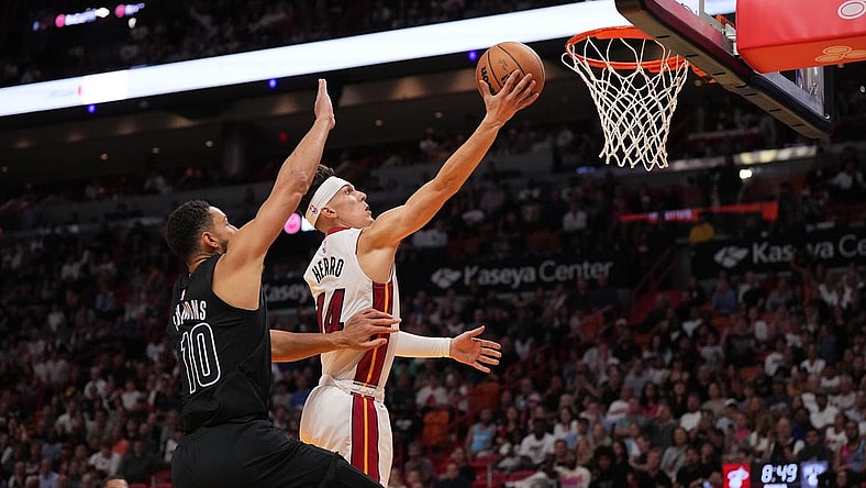 Nov 1, 2023; Miami, Florida, USA; Miami Heat guard Tyler Herro (14) shoots the ball around Brooklyn Nets guard Ben Simmons (10) during the second half at Kaseya Center. Mandatory Credit: Jasen Vinlove-USA TODAY Sports
