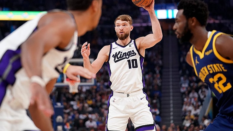 Nov 1, 2023; San Francisco, California, USA; Sacramento Kings forward Domantas Sabonis (10) holds onto the ball against the Golden State Warriors in the first quarter at the Chase Center. Mandatory Credit: Cary Edmondson-USA TODAY Sports