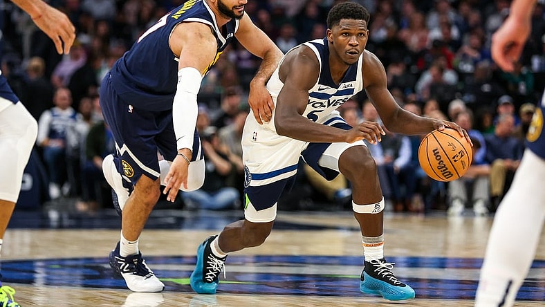 Nov 1, 2023; Minneapolis, Minnesota, USA; Minnesota Timberwolves guard Anthony Edwards (5) drives while Denver Nuggets guard Jamal Murray (27) defends during the second half at Target Center. Mandatory Credit: Matt Krohn-USA TODAY Sports
