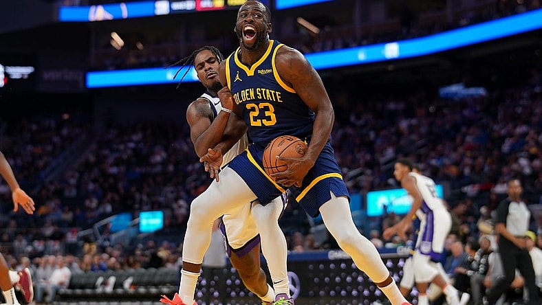 Nov 1, 2023; San Francisco, California, USA; Golden State Warriors forward Draymond Green (23) is fouled by Sacramento Kings guard Davion Mitchell (15) in the third quarter at the Chase Center. Mandatory Credit: Cary Edmondson-USA TODAY Sports