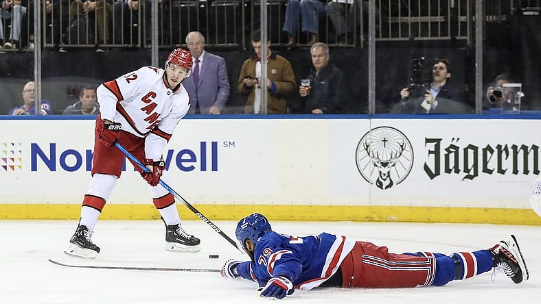 Nov 2, 2023; New York, New York, USA; New York Rangers defenseman K'Andre Miller (79) tries to deflect a pass attempt by Carolina Hurricanes center Jesperi Kotkaniemi (82) in the first period at Madison Square Garden. Mandatory Credit: Wendell Cruz-USA TODAY Sports
