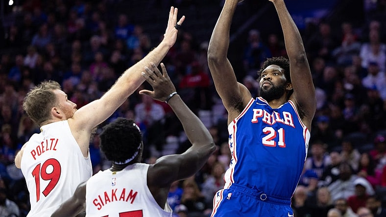 Nov 2, 2023; Philadelphia, Pennsylvania, USA; Philadelphia 76ers center Joel Embiid (21) shoots the ball past Toronto Raptors center Jakob Poeltl (19) and forward Pascal Siakam (43) during the second quarter at Wells Fargo Center. Mandatory Credit: Bill Streicher-USA TODAY Sports