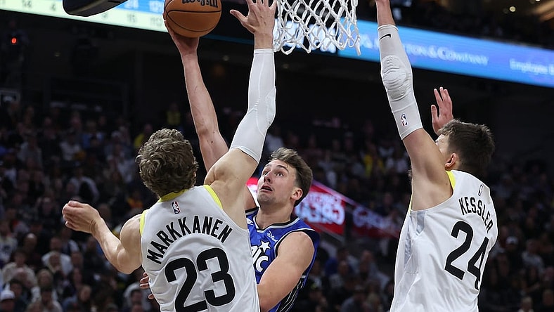 Nov 2, 2023; Salt Lake City, Utah, USA; Orlando Magic forward Franz Wagner (22) goes to the basket against Utah Jazz forward LauriMarkkanen (23) and center Walker Kessler (24) in the second quarter at the Delta Center. Mandatory Credit: Rob Gray-USA TODAY Sports