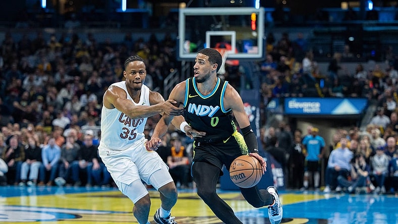 Nov 3, 2023; Indianapolis, Indiana, USA; Indiana Pacers guard Tyrese Haliburton (0) dribbles while Cleveland Cavaliers forward Isaac Okoro (35) defends in the first half at Gainbridge Fieldhouse. Mandatory Credit: Trevor Ruszkowski-USA TODAY Sports
