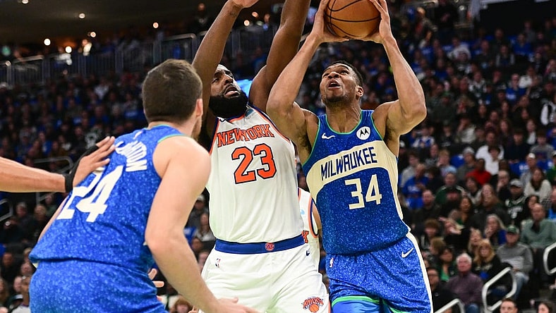 Nov 3, 2023; Milwaukee, Wisconsin, USA; Milwaukee Bucks forward Giannis Antetokounmpo (34) takes a shot against New York Knicks center Mitchell Robinson (23) in the second quarter at Fiserv Forum. Mandatory Credit: Benny Sieu-USA TODAY Sports