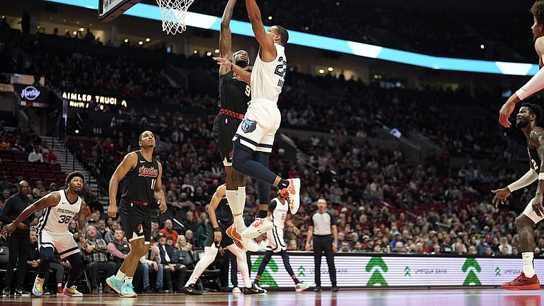 Nov 3, 2023; Portland, Oregon, USA; Memphis Grizzlies shooting guard Desmond Bane (22) shoots under pressure from Portland Trail Blazers small forward Jerami Grant (9) during the first half at Moda Center. Mandatory Credit: Soobum Im-USA TODAY Sports