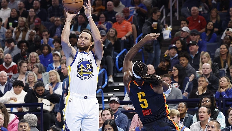 Nov 3, 2023; Oklahoma City, Oklahoma, USA; Golden State Warriors guard Stephen Curry (30) shoots a thee point basket against Oklahoma City Thunder guard Luguentz Dort (5) during the second half at Paycom Center.  Mandatory Credit: Alonzo Adams-USA TODAY Sports