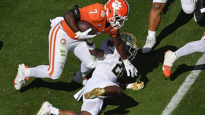 Nov 4, 2023; Clemson, South Carolina, USA; Clemson Tigers running back Phil Mafah (7) runs against Notre Dame Fighting Irish safety Adon Shuler (21) during the first quarter at Memorial Stadium. Mandatory Credit: Ken Ruinard-USA TODAY Sports