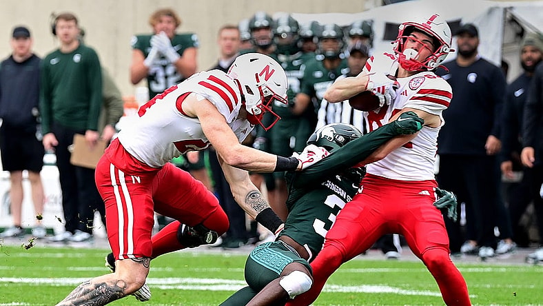 Nov 4, 2023; East Lansing, Michigan, USA;  Michigan State Spartans defensive back Caleb Coley (3) tackles Nebraska Cornhuskers wide receiver Alex Bullock (84) in spite of  tight end Thomas Fidone II (24) at Spartan Stadium. Mandatory Credit: Dale Young-USA TODAY Sports
