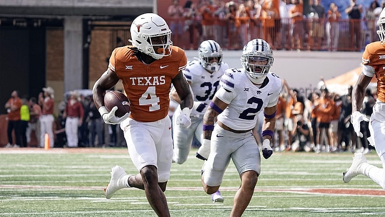 Nov 4, 2023; Austin, Texas, USA; Texas Longhorns running back CJ Baxter (4) runs for a touchdown while being chased by Kansas State Wildcats defensive back Kobe Savage (2) during the first half at Darrell K Royal-Texas Memorial Stadium. Mandatory Credit: Scott Wachter-USA TODAY Sports