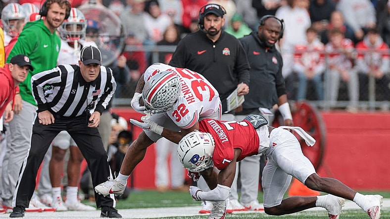 Nov 4, 2023; Piscataway, New Jersey, USA; Ohio State Buckeyes running back TreVeyon Henderson (32) is tackled by Rutgers Scarlet Knights defensive back Robert Longerbeam (7) during the first half at SHI Stadium. Mandatory Credit: Vincent Carchietta-USA TODAY Sports