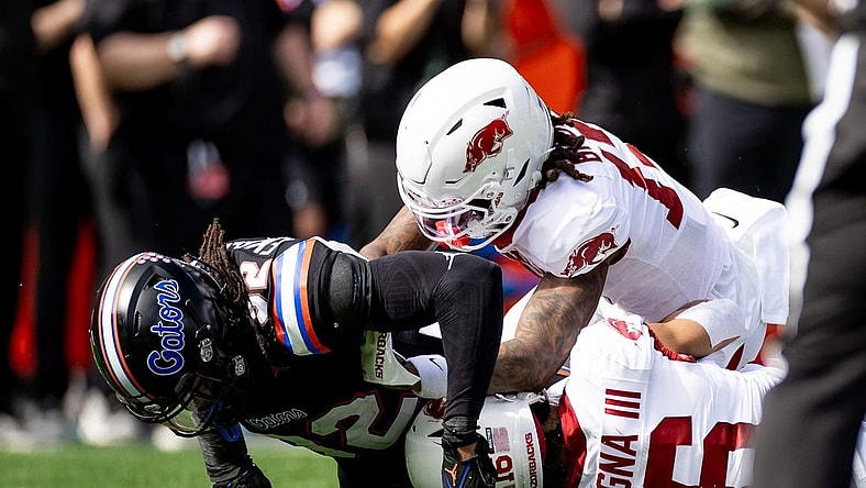Florida Gators safety Cahron Rackley (32) tackles Arkansas Razorbacks wide receiver Isaiah Sategna (16) during a kickoff during the first half at Steve Spurrier Field at Ben Hill Griffin Stadium in Gainesville, FL on Saturday, November 4, 2023. [Matt Pendleton/Gainesville Sun]