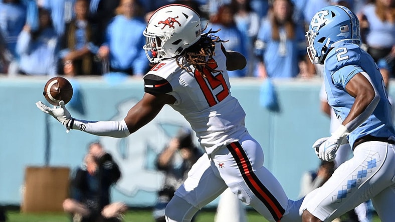 Nov 4, 2023; Chapel Hill, North Carolina, USA; Campbell Fighting Camels tight end Javonte Kinsey (15) catches the ball as North Carolina Tar Heels defensive back Don Chapman (2) defends in the first quarter at Kenan Memorial Stadium. Mandatory Credit: Bob Donnan-USA TODAY Sports