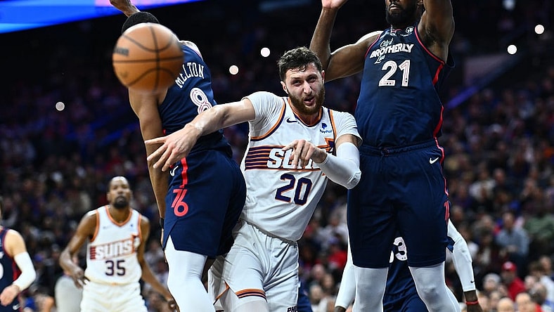 Nov 4, 2023; Philadelphia, Pennsylvania, USA; Phoenix Suns center Jusuf Nurkic (20) passes the ball between Philadelphia 76ers center Joel Embiid (21) and guard De'Anthony Melton (8) in the first quarter at Wells Fargo Center. Mandatory Credit: Kyle Ross-USA TODAY Sports