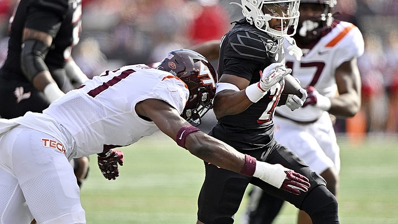 Nov 4, 2023; Louisville, Kentucky, USA;  Louisville Cardinals running back Jawhar Jordan (25) runs the ball against Virginia Tech Hokies linebacker Keli Lawson (21) during the first quarter at L&N Federal Credit Union Stadium. Mandatory Credit: Jamie Rhodes-USA TODAY Sports