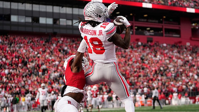 Nov 4, 2023; Piscataway, New Jersey, USA; Ohio State Buckeyes wide receiver Marvin Harrison Jr. (18) catches a 4-yard touchdown in front of Rutgers Scarlet Knights defensive back Robert Longerbeam (7) during the second half of the NCAA football game at SHI Stadium. Ohio State won 35-16.