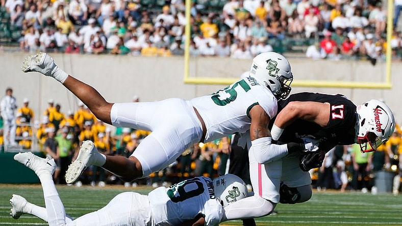 Nov 4, 2023; Waco, Texas, USA;  Houston Cougars tight end Mike O'Laughlin (17) makes a catch against Baylor Bears cornerback Caden Jenkins (19) and linebacker Garmon Randolph (55) during the first half at McLane Stadium. Mandatory Credit: Chris Jones-USA TODAY Sports